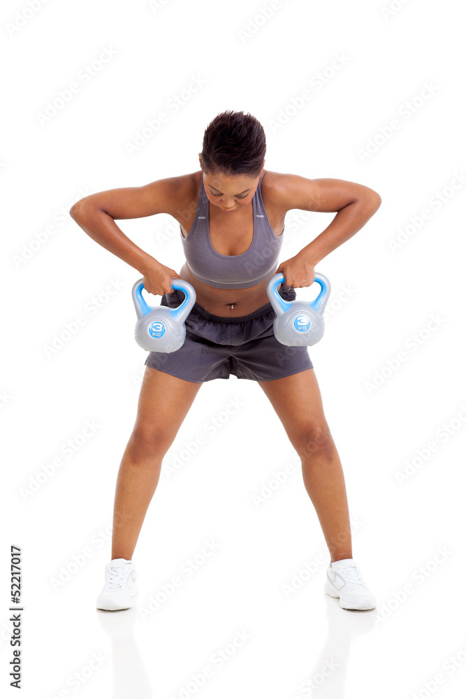 young african woman lift kettle bell weights young african woman lift kettle bell weights