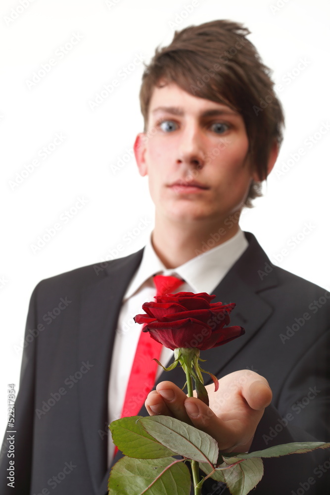 Young man presenting a flower red rose isolated Young man presenting a flower red rose isolated