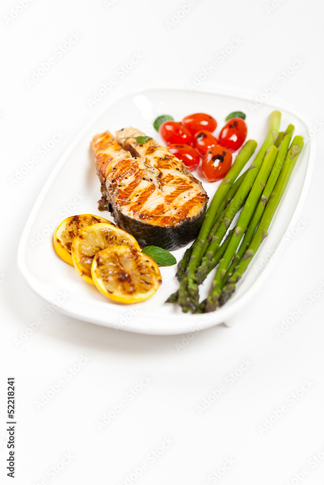 Grilled salmon steak with asparagus and cherry tomatoes