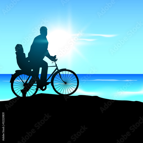 Silhouette of a father and his child go for cycle ride at sunse