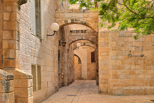 Narrow street and stonrd houses at jewish quarter in Jerusalem.