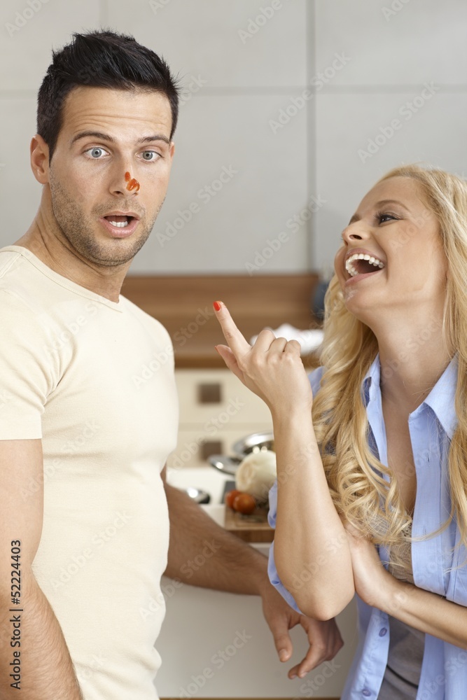 Young couple having fun in kitchen