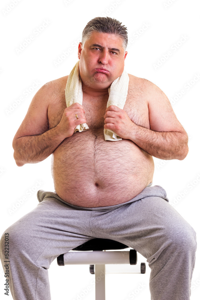 Overweight man resting on a bench for abdominals, tired after tr