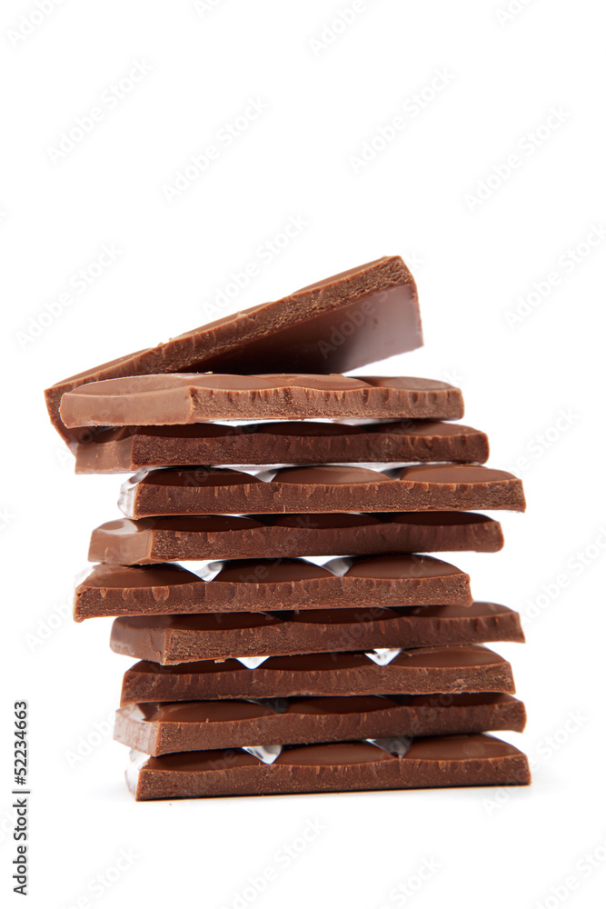 Stack of chocolate pieces on a white background. Stack of chocolate pieces on a white background.