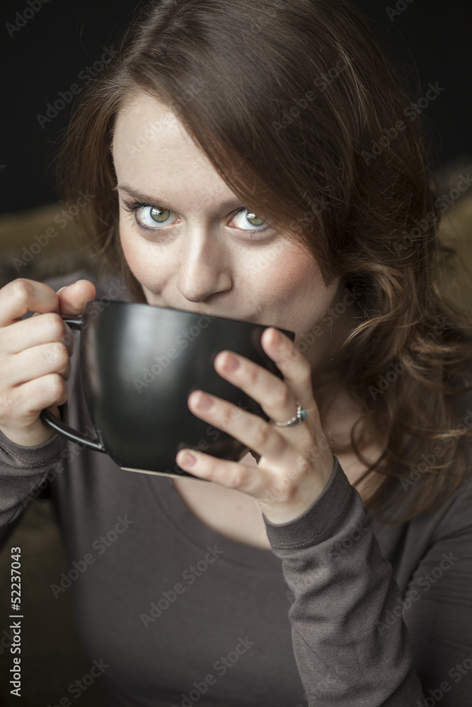 Young Woman with Beautiful Green Eyes and Black Coffee Cup Young Woman with Beautiful Green Eyes and Black Coffee Cup