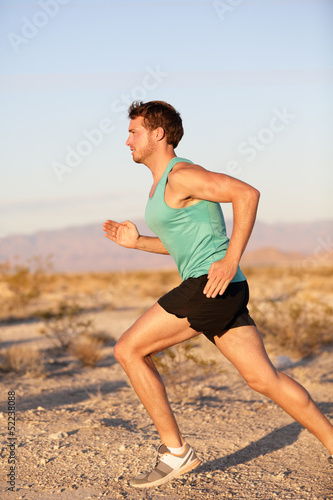 Runner sport man running and sprinting outside