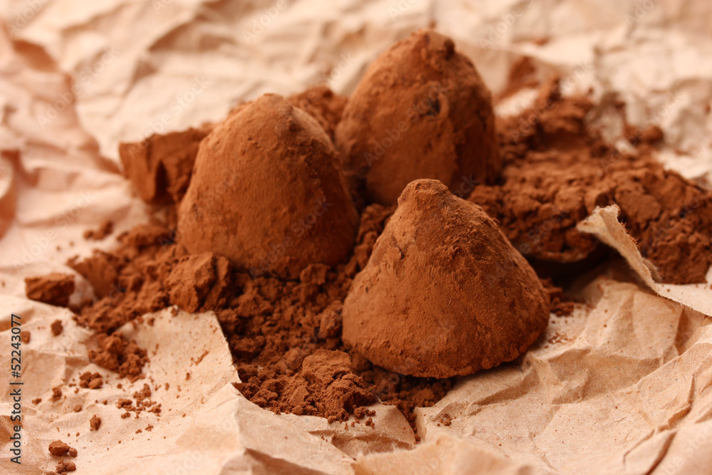 Chocolate truffles and cocoa, on brown background Chocolate truffles and cocoa, on brown background