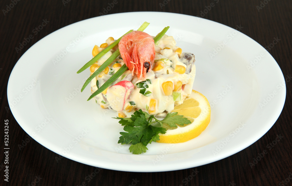 Small portion of food on big plate on wooden table Small portion of food on big plate on wooden table