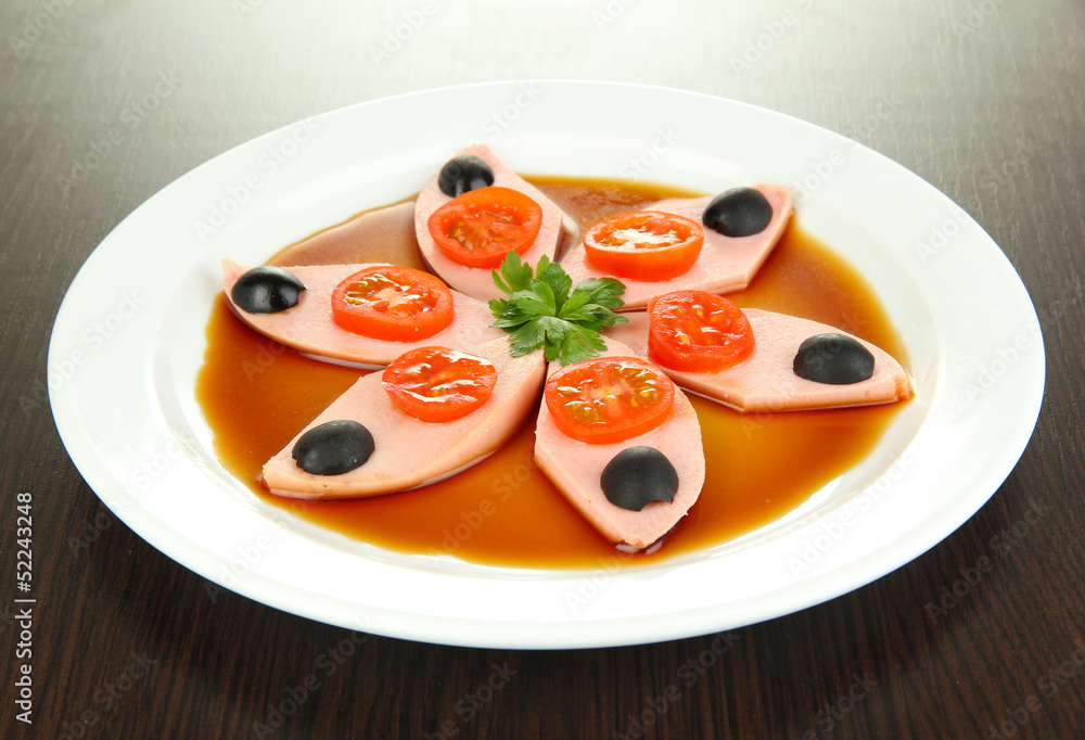Small portion of food on big plate on wooden table Small portion of food on big plate on wooden table