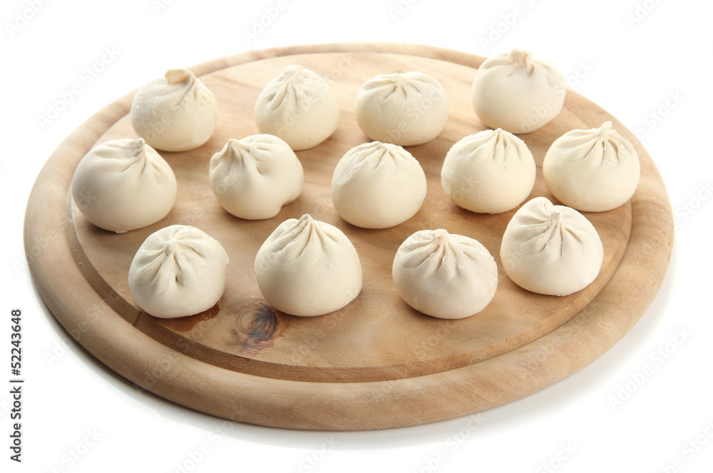 Raw khinkali on wooden desk, isolated on white Raw khinkali on wooden desk, isolated on white