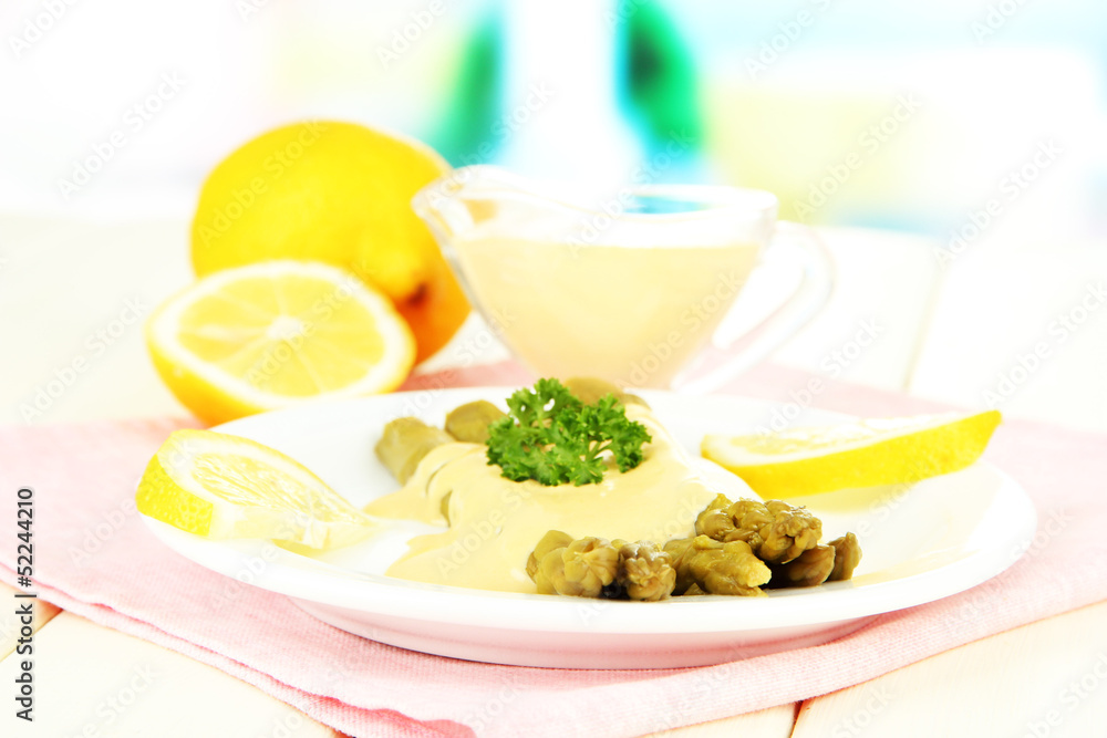 Asparagus on plate, on wooden table on bright background