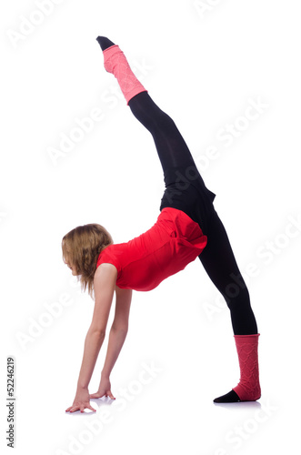 Young gymnast exercising on white