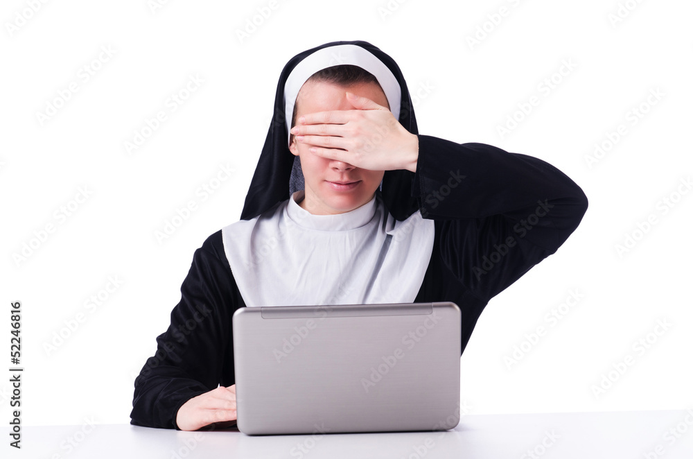 Nun working on laptop - religious concept Nun working on laptop - religious concept