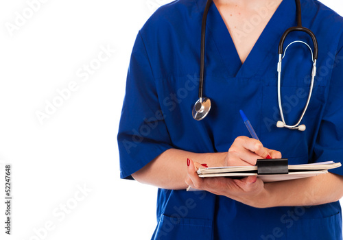 Cropped view of a doctor writing in a medical report