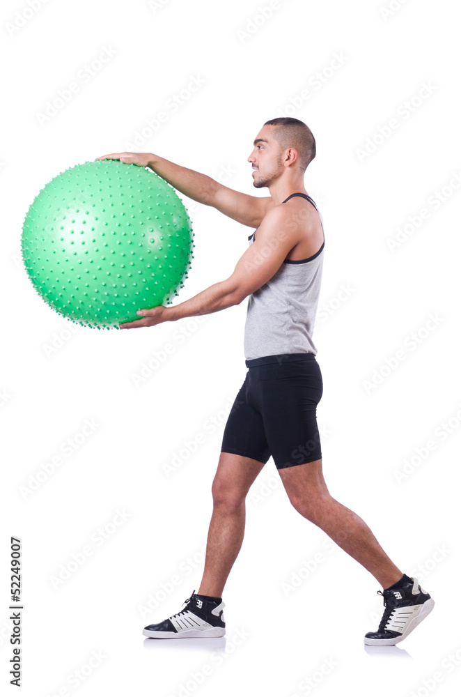 Man with swiss ball doing exercises on white Man with swiss ball doing exercises on white
