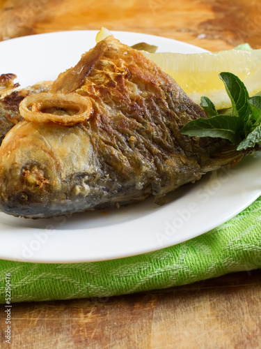 Fried fish on plate photo