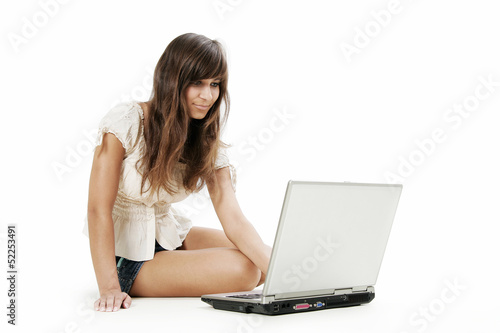 Young woman working with laptop on white background