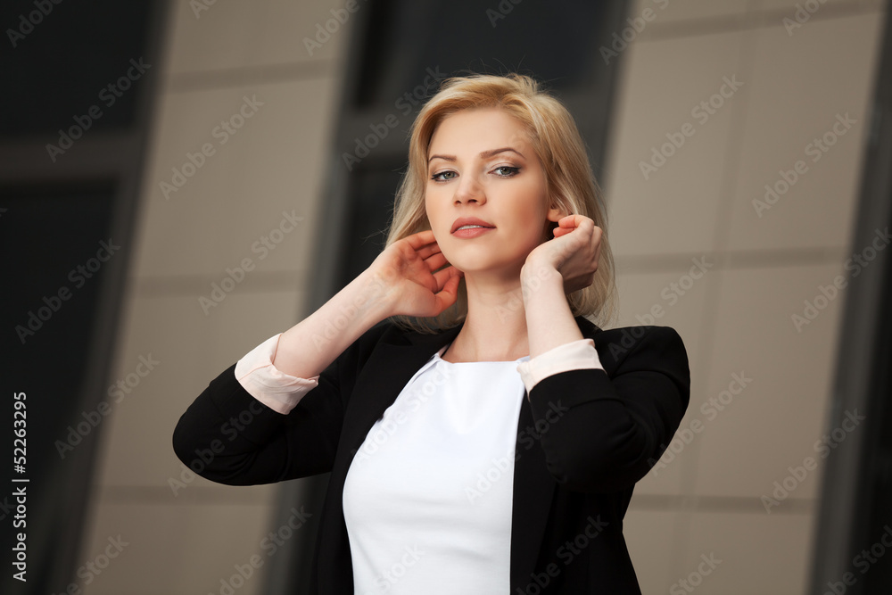 Young business woman walking on the city street Young business woman walking on the city street