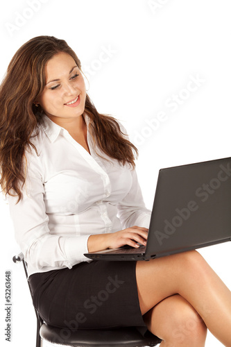 Portrait of successful businesswoman working with laptop