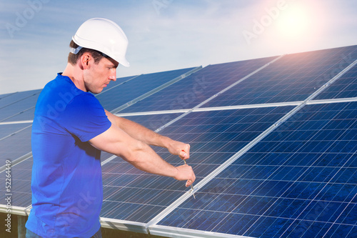 technician maintaining solar panels