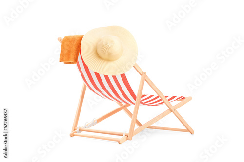 Фотография Towel and hat on a sun lounger with stripes