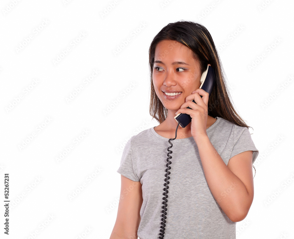 Smiling asiatic young woman speaking on phone Smiling asiatic young woman speaking on phone
