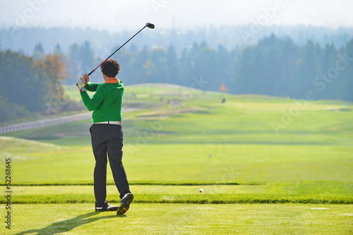 Golfer swing, teeing off on beautiful summer morning