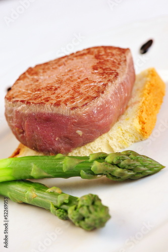 Grilled steak on bread slice and asparagus