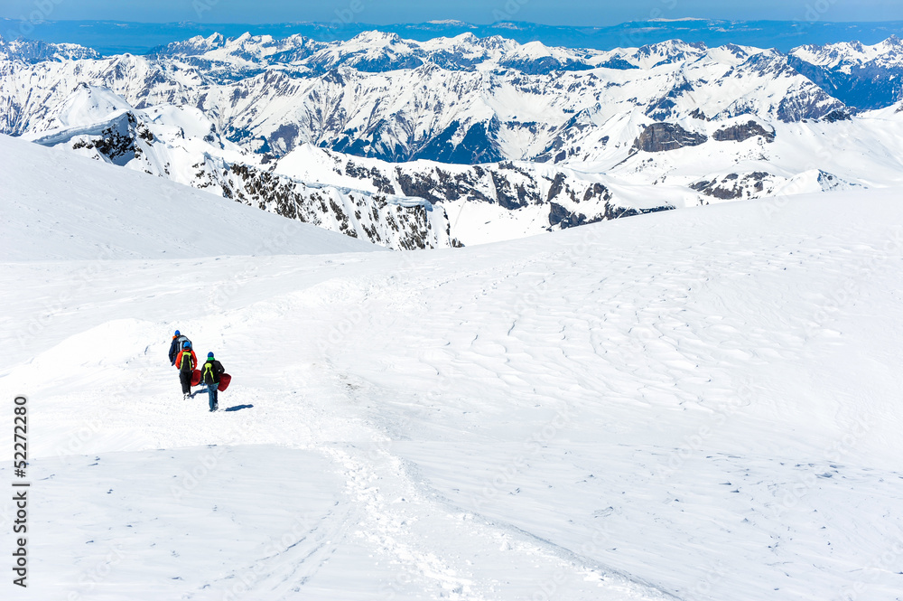 A group of mountain hiker walking on the snow into the mountain A group of mountain hiker walking on the snow into the mountain