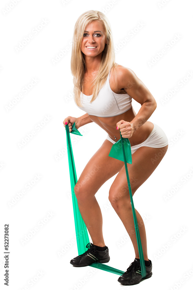 Lovely woman doing fitness exercises with rubber band Lovely woman doing fitness exercises with rubber band