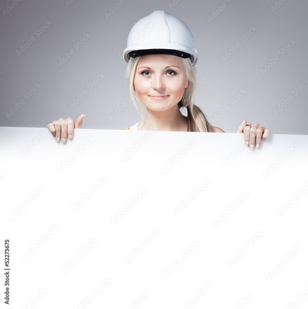 Young builder woman construction worker, empty banner Young builder woman construction worker, empty banner