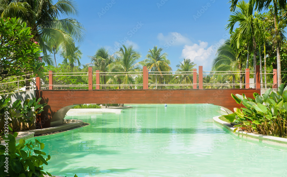 Wooden bridge over the swimming pool.