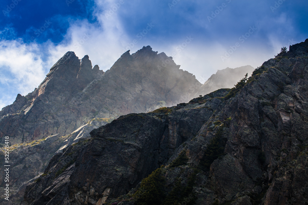 Rocky peaks and storm clouds over French Alps, in summer Rocky peaks and storm clouds over French Alps, in summer