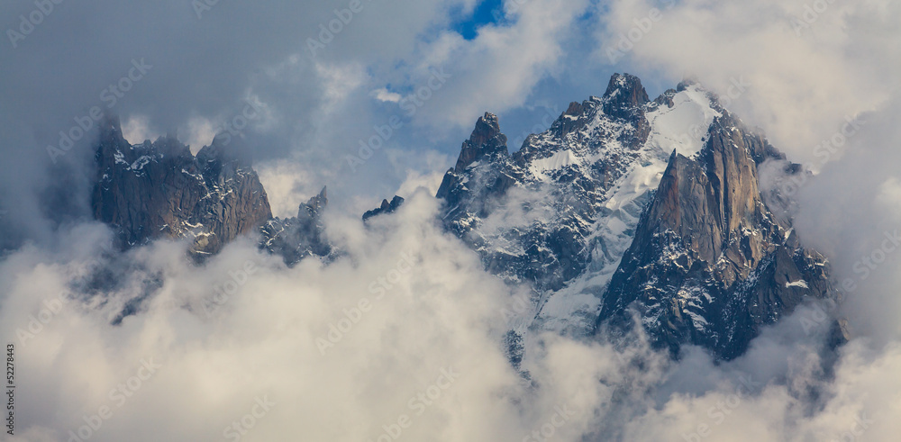 Rocky peaks and storm clouds over French Alps, in summer