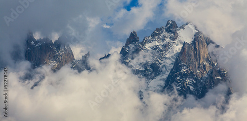 Rocky peaks and storm clouds over French Alps, in summer