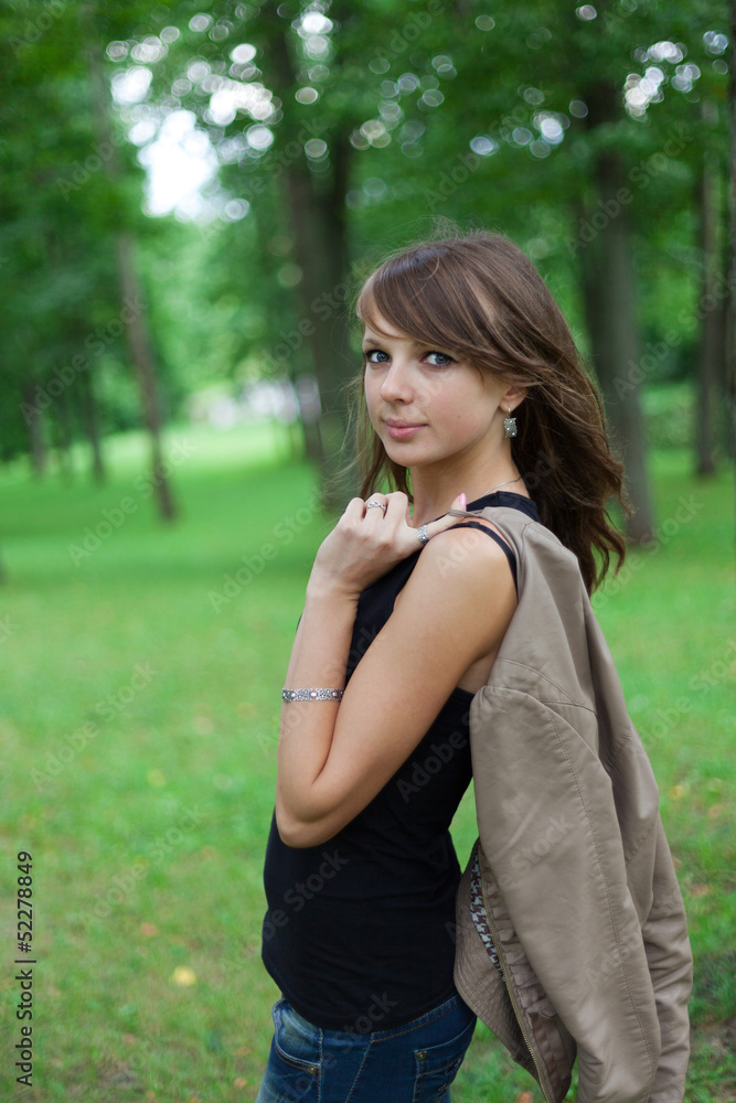 Portrait of a beautiful woman posing in the park in the summer Portrait of a beautiful woman posing in the park in the summer