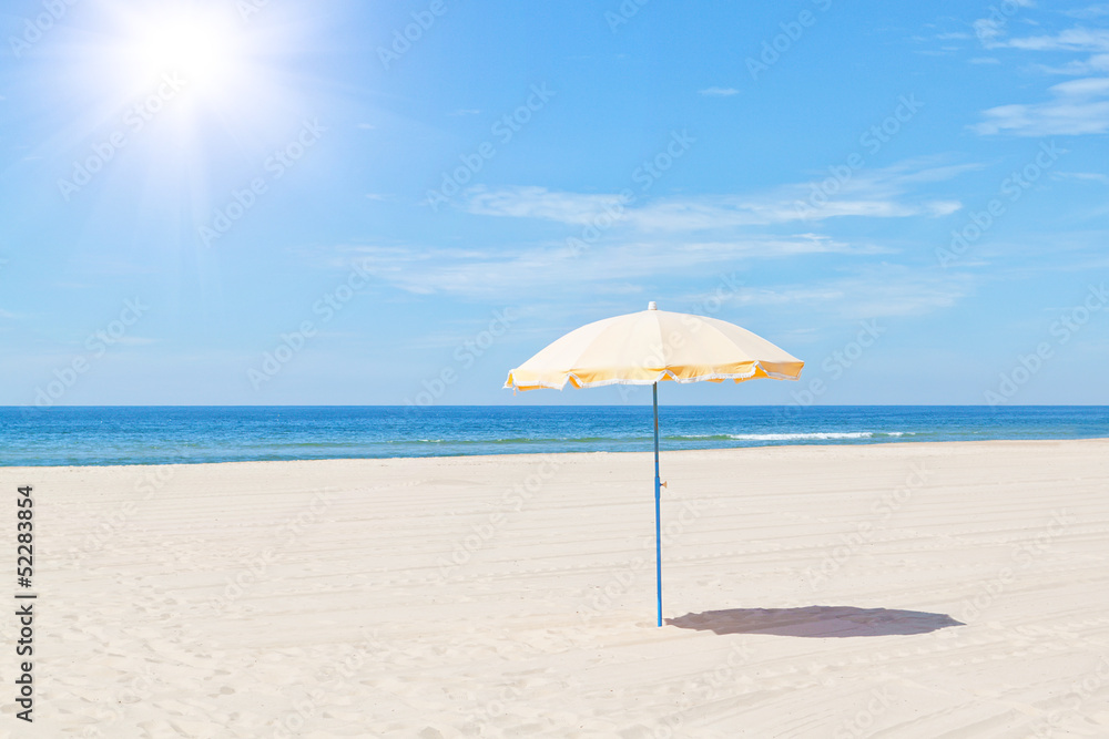 The only beach umbrella on the sea in summer under the sun.