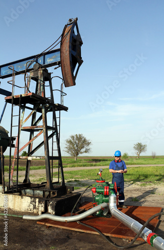 oil worker with tablet pc check pipeline