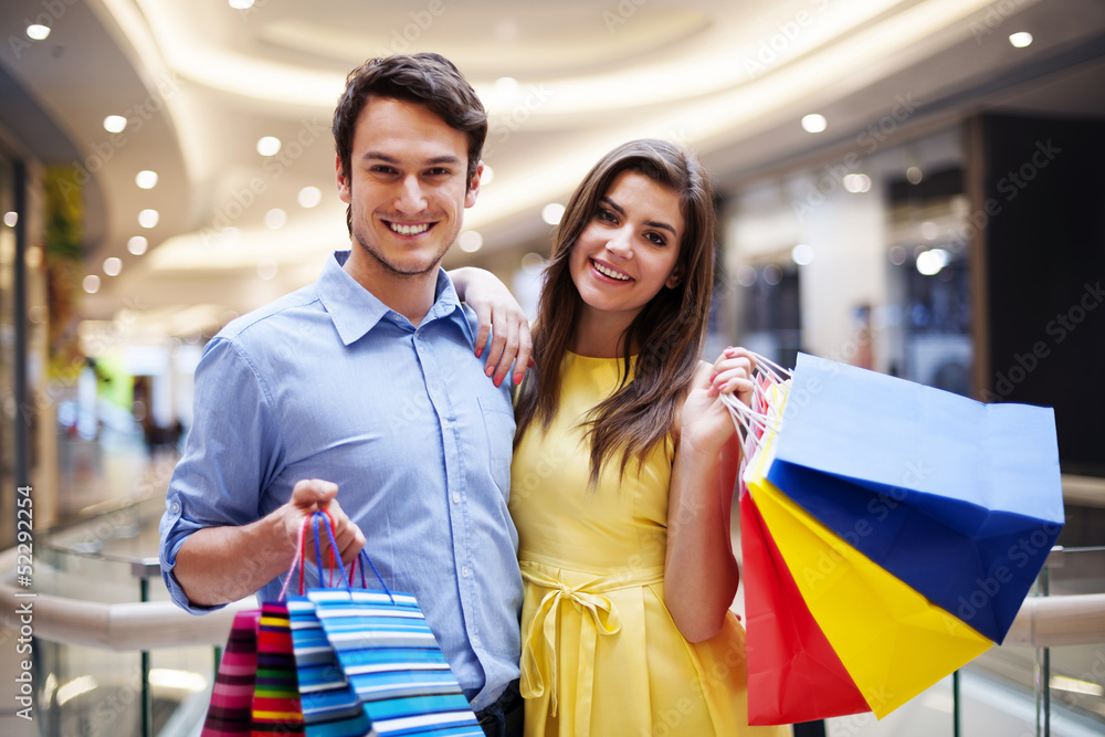 Portrait of happy couple with shopping bags. Portrait of happy couple with shopping bags.