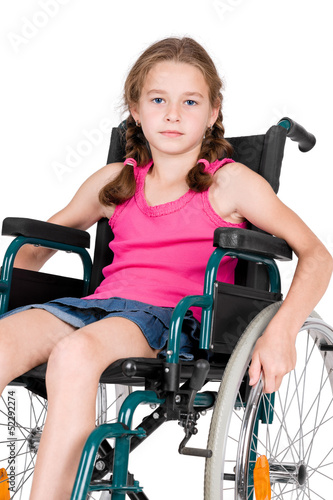 Young handicapped girl in a wheelchair over white background.