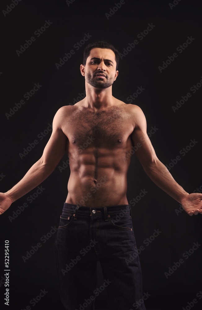 Fototapeta premium Shirtless Man on Dark Background Gesturing