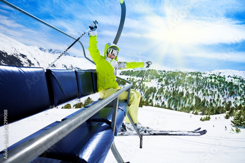 Happy skier on ski lift photo