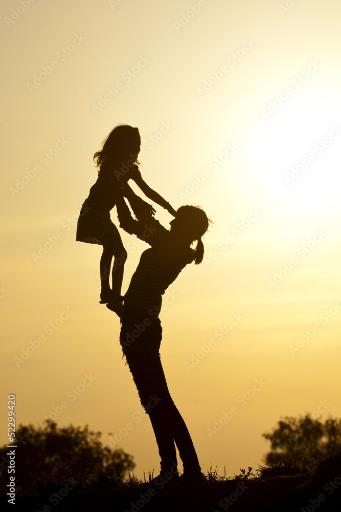 girls playing in the sunset