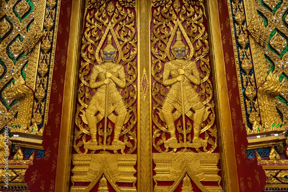 Golden temple gate with guarding demon