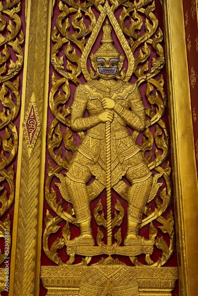 Golden temple gate with guarding demon