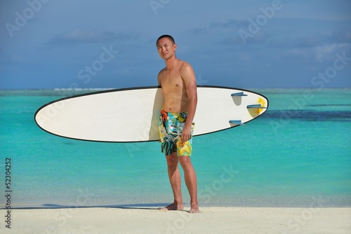 Man with surf board on beach