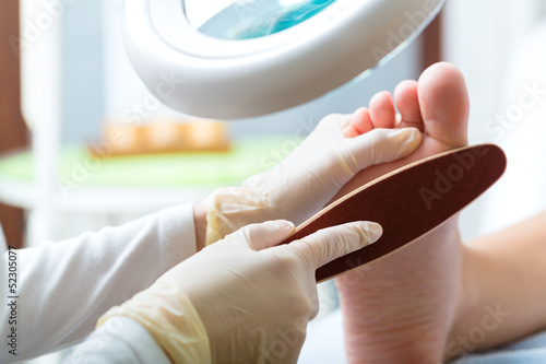 Woman receiving podiatry treatment in Day Spa