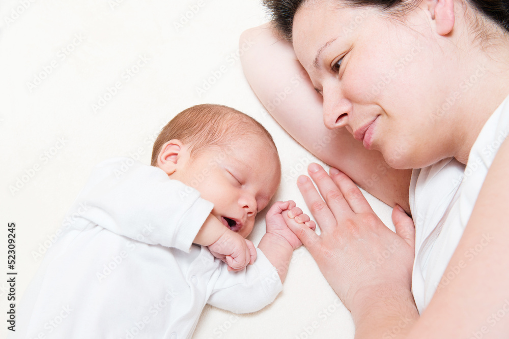 mother watching her month old son sleeping in bed mother watching her month old son sleeping in bed