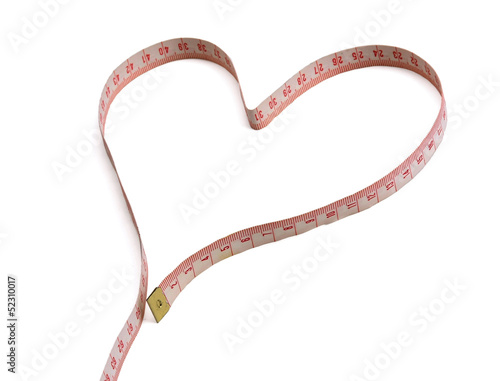 A measuring tape shaping a heart isolated on white background