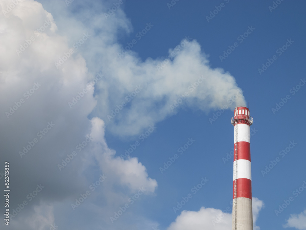 Industrial smokestack on blue sky